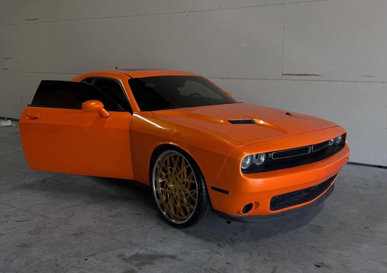 Dodge Challenger in gloss orange with gold wheels
