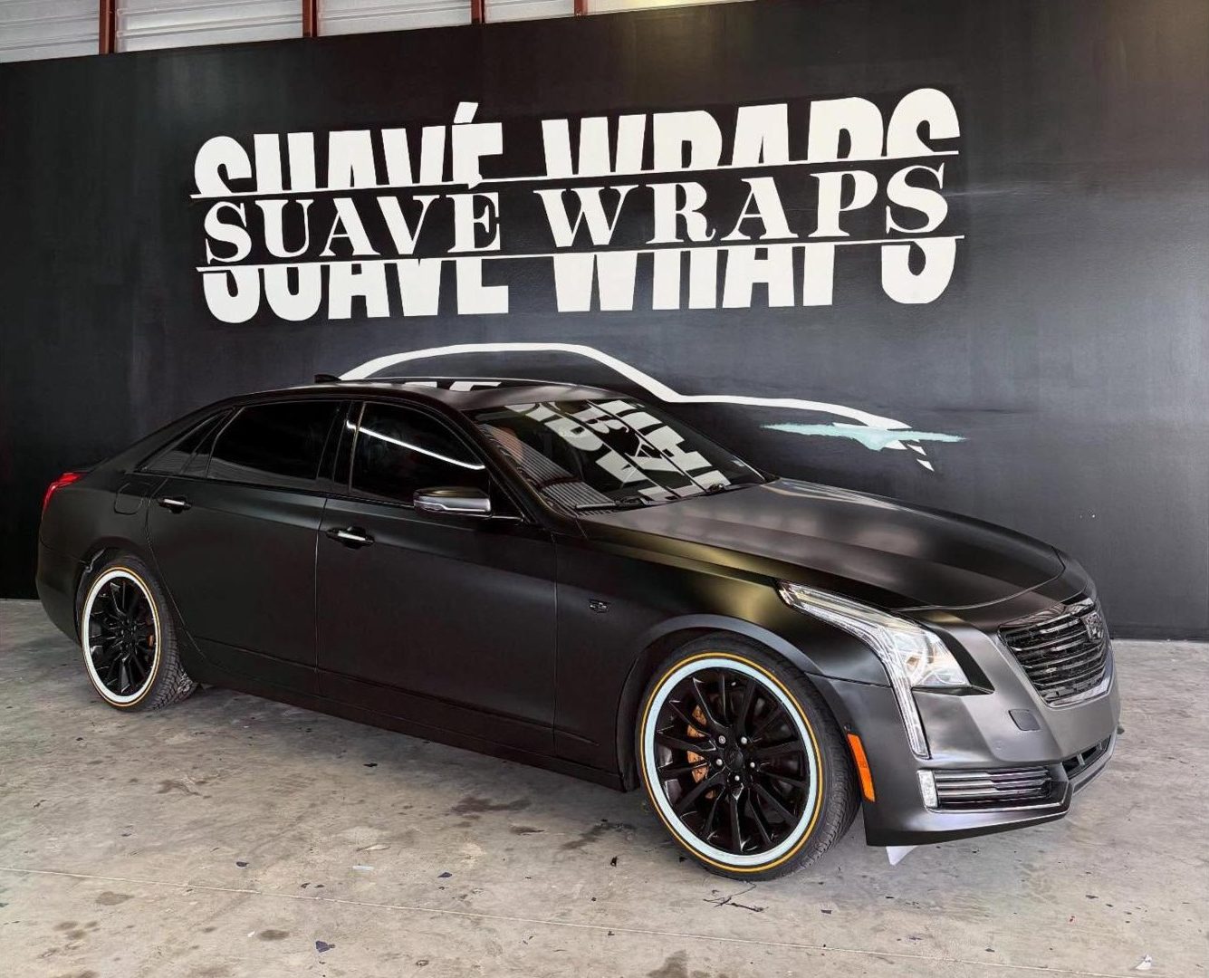 Cadillac CT6 in satin black in front of the painted Suave Wraps wall