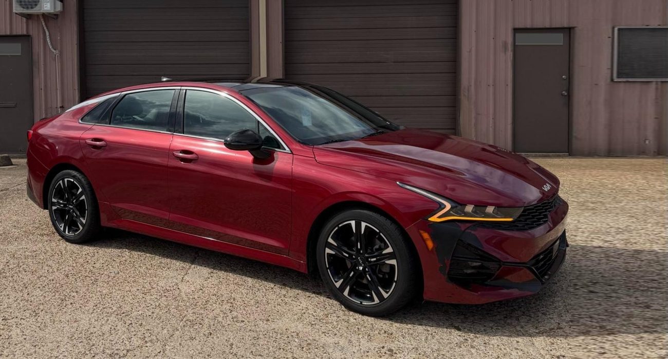 Before: the same Kia K5 in factory red