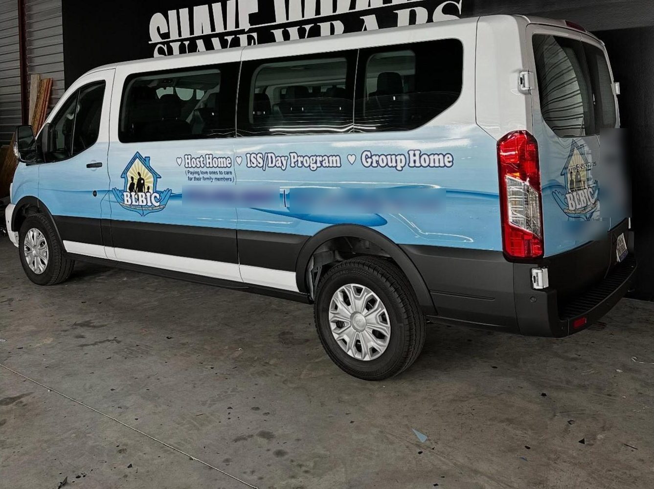 Passenger van with a full commercial wrap for a local care business